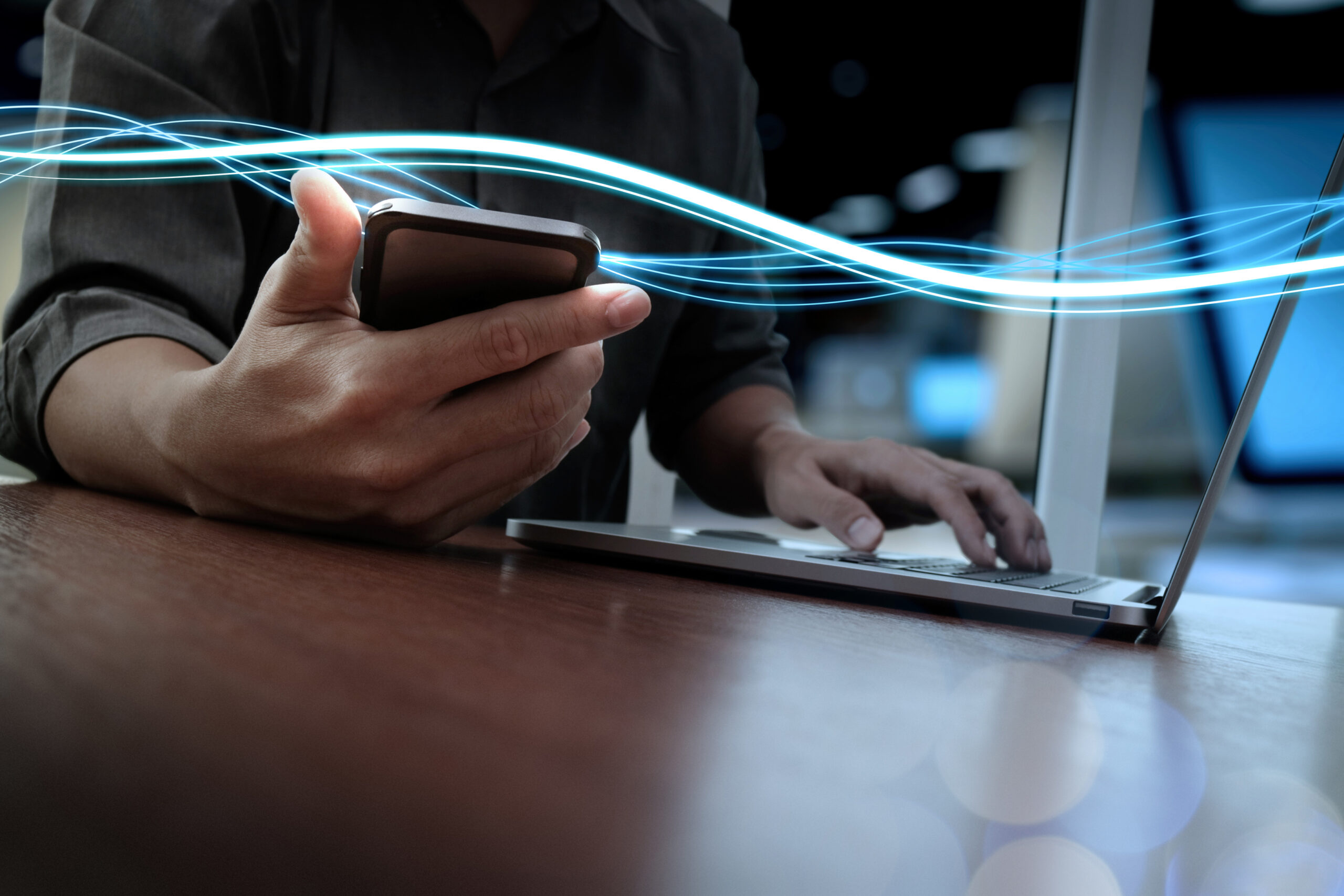 Waves of blue light and businessman using on smartphone as conce Data protection