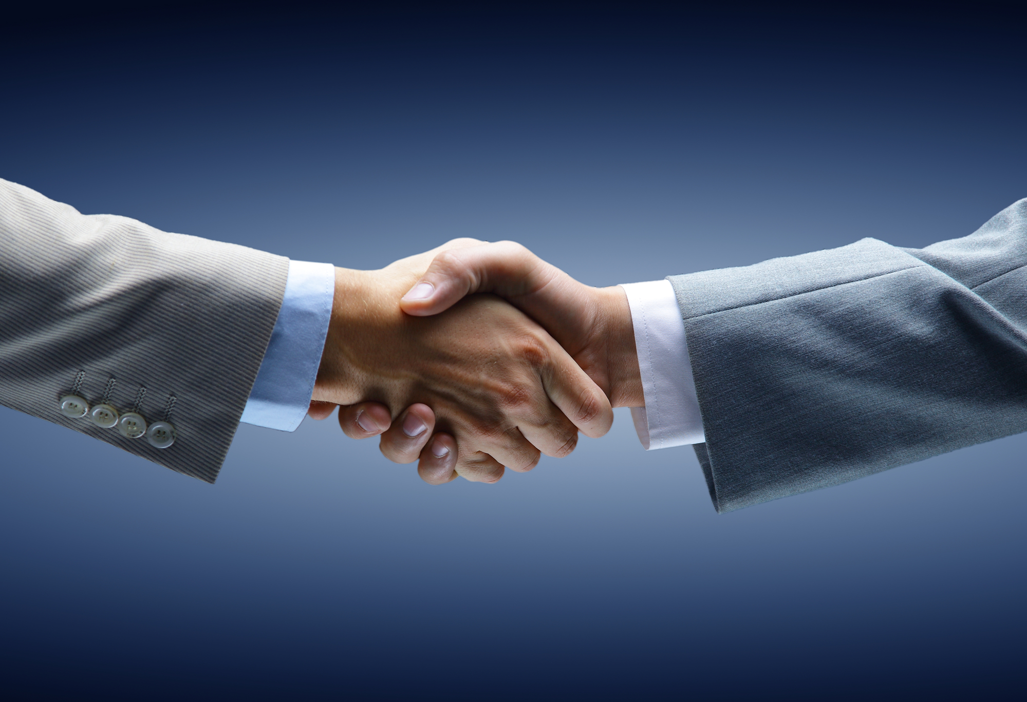 Handshake - Hand holding on black background Handshake